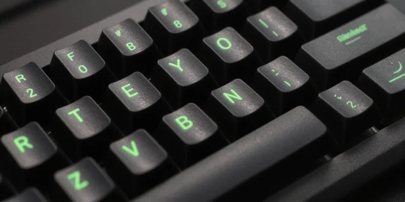 Close up of a mechanical keyboard with glowing green terminal text reflecting on the keycaps